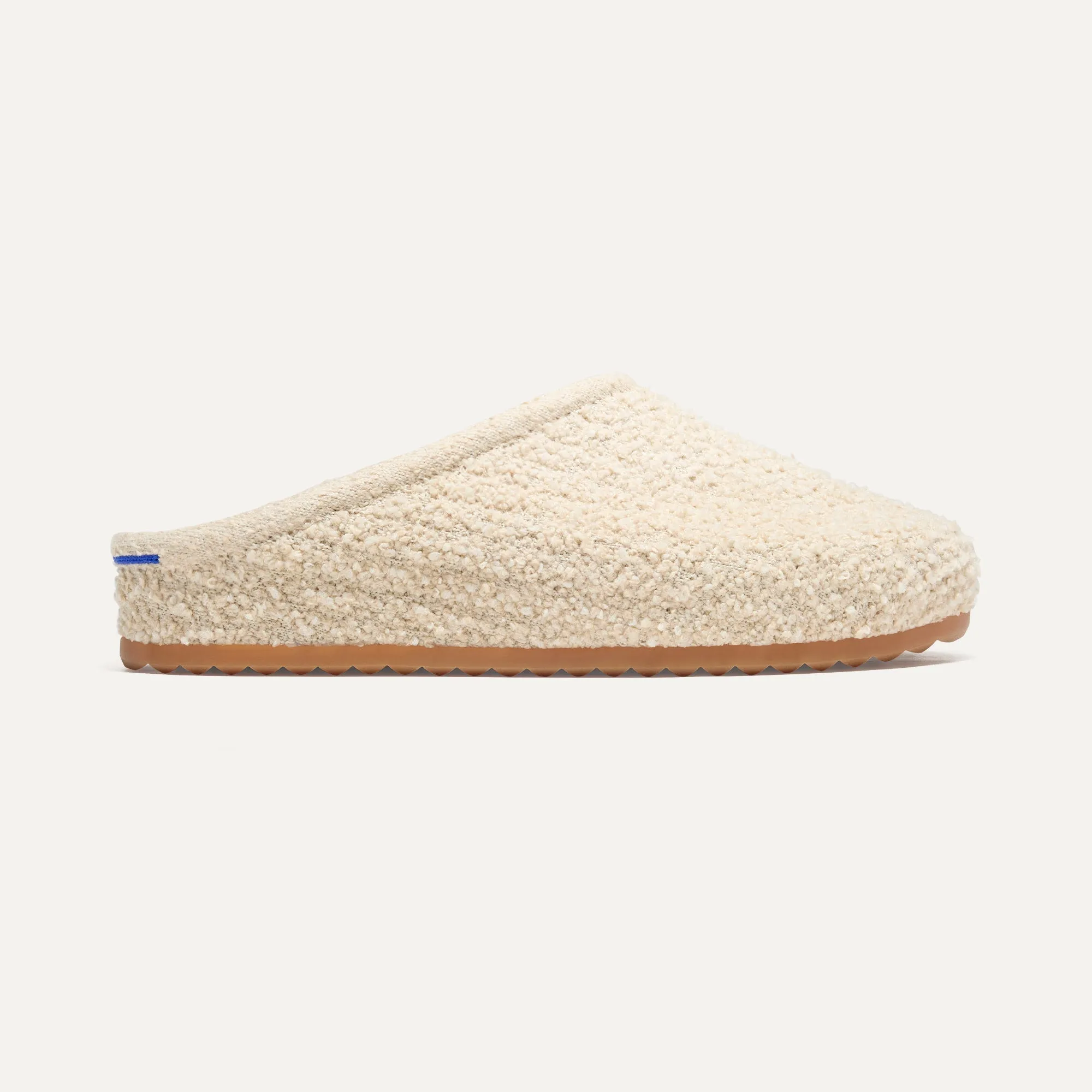 The Cozy Clog - Honeybun Bouclé. Optimize the title of this e-commerce product and return a version with descriptive modifiers.

Optimized Title: Warm and Plush Honeybun Bouclé Cozy Clog Slippers