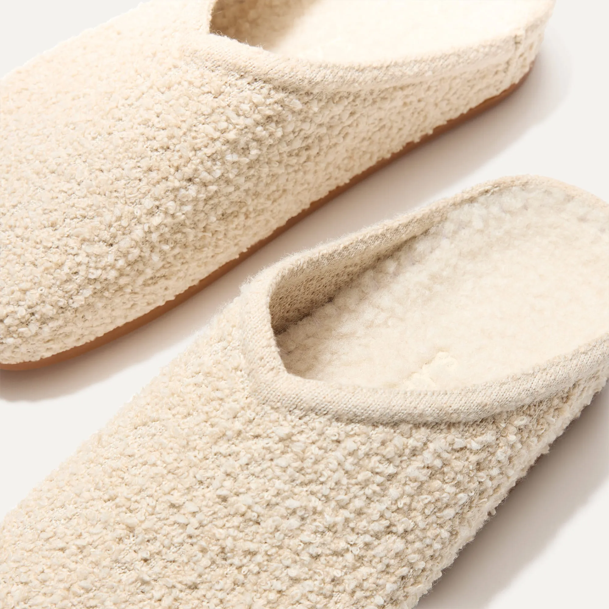 The Cozy Clog - Honeybun Bouclé. Optimize the title of this e-commerce product and return a version with descriptive modifiers.

Optimized Title: Warm and Plush Honeybun Bouclé Cozy Clog Slippers